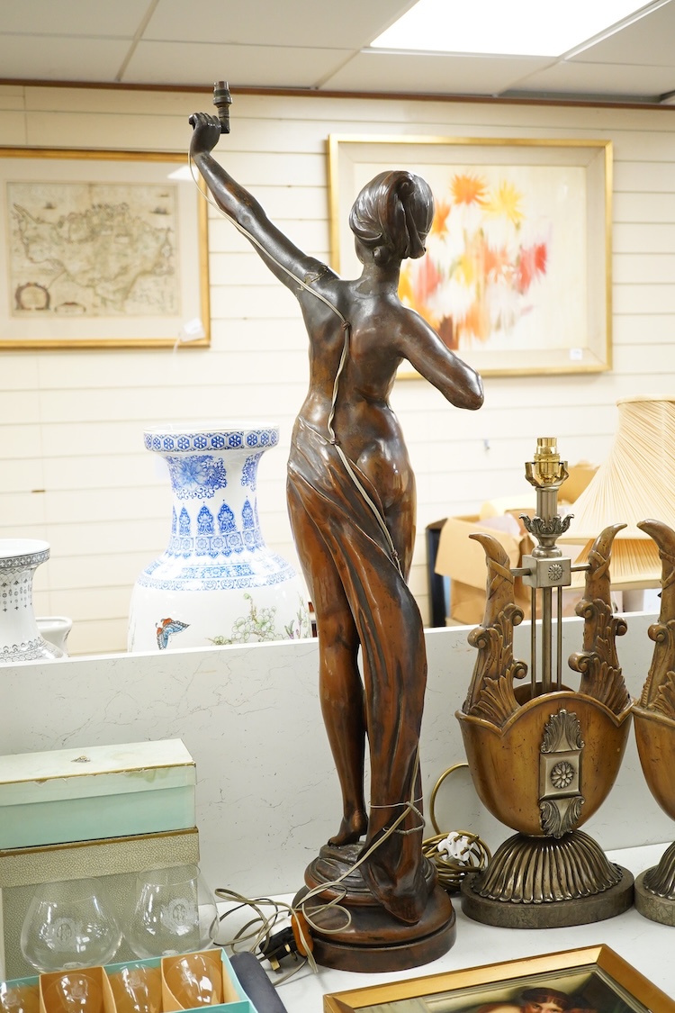 A large bronzed composition figurine of a lady, converted to an electric lamp, 104cm high